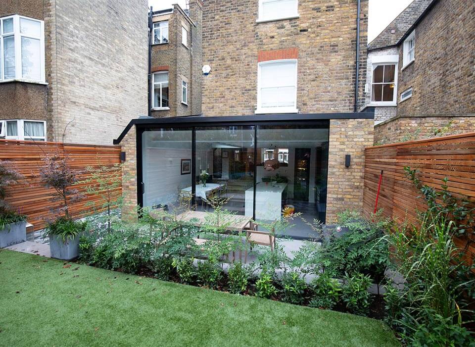 black slimline aluminium sliding doors on brick house